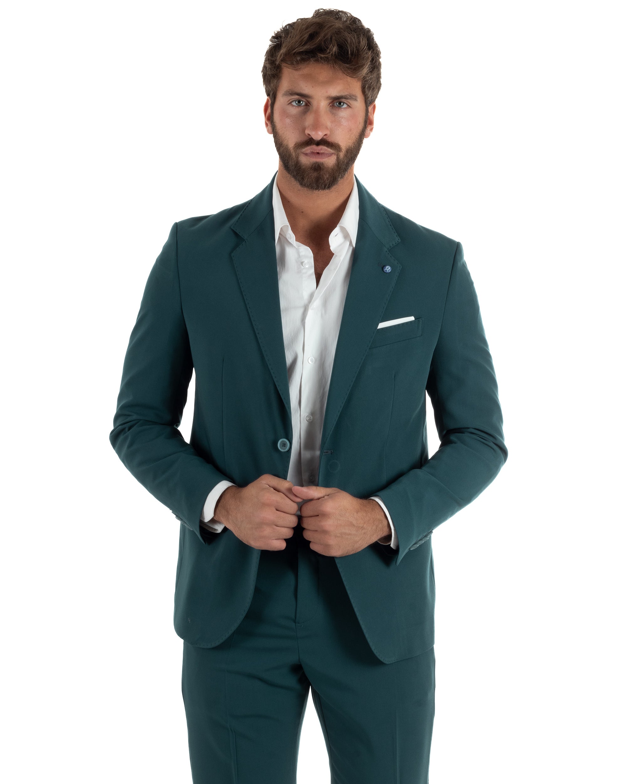 Vista frontale completo uomo petrolio monopetto giacca strutturata pantaloni slim affusolati