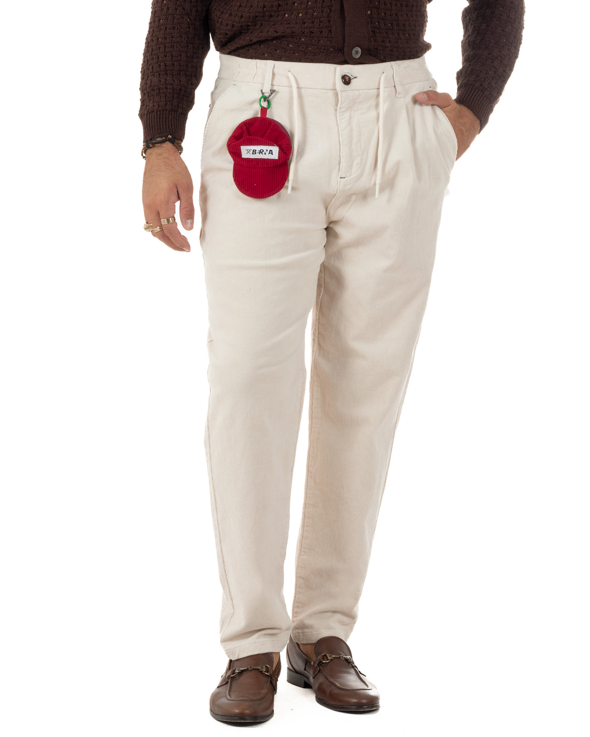 Pantaloni uomo in velluto panna a coste sottili, con pinces e coulisse, abbinati a mocassini marroni.
