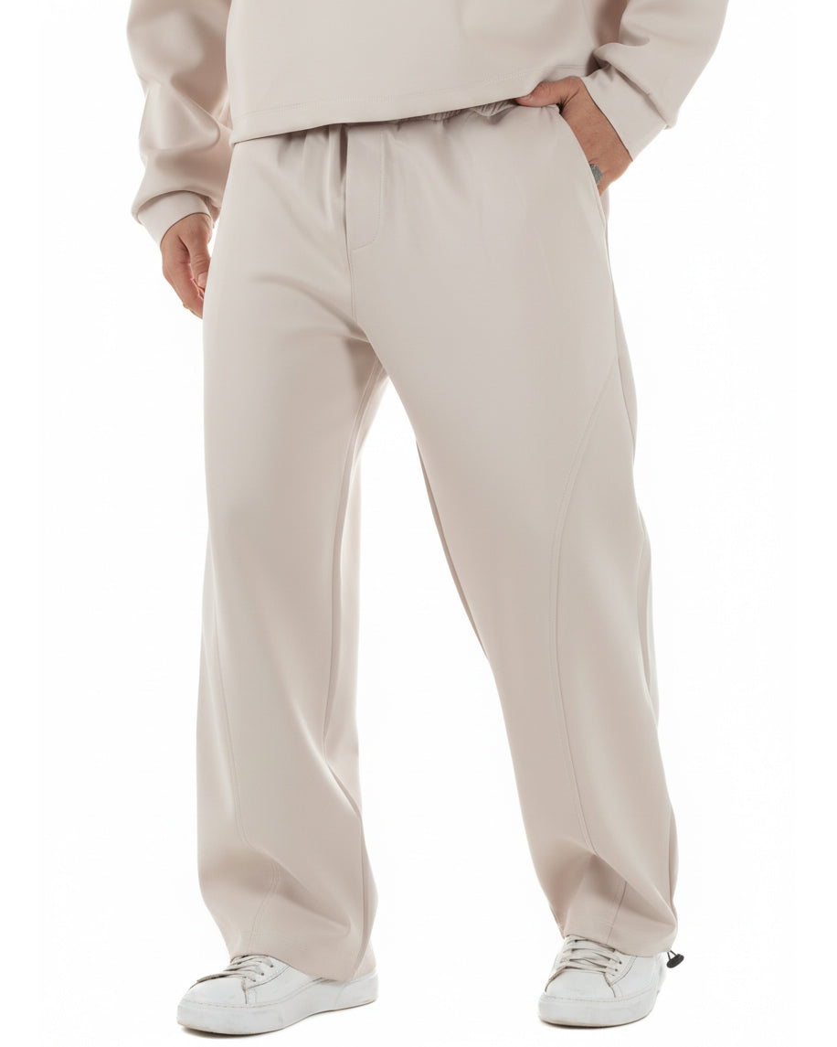 Dettaglio pantaloni baggy panna con elastico in vita e coulisse