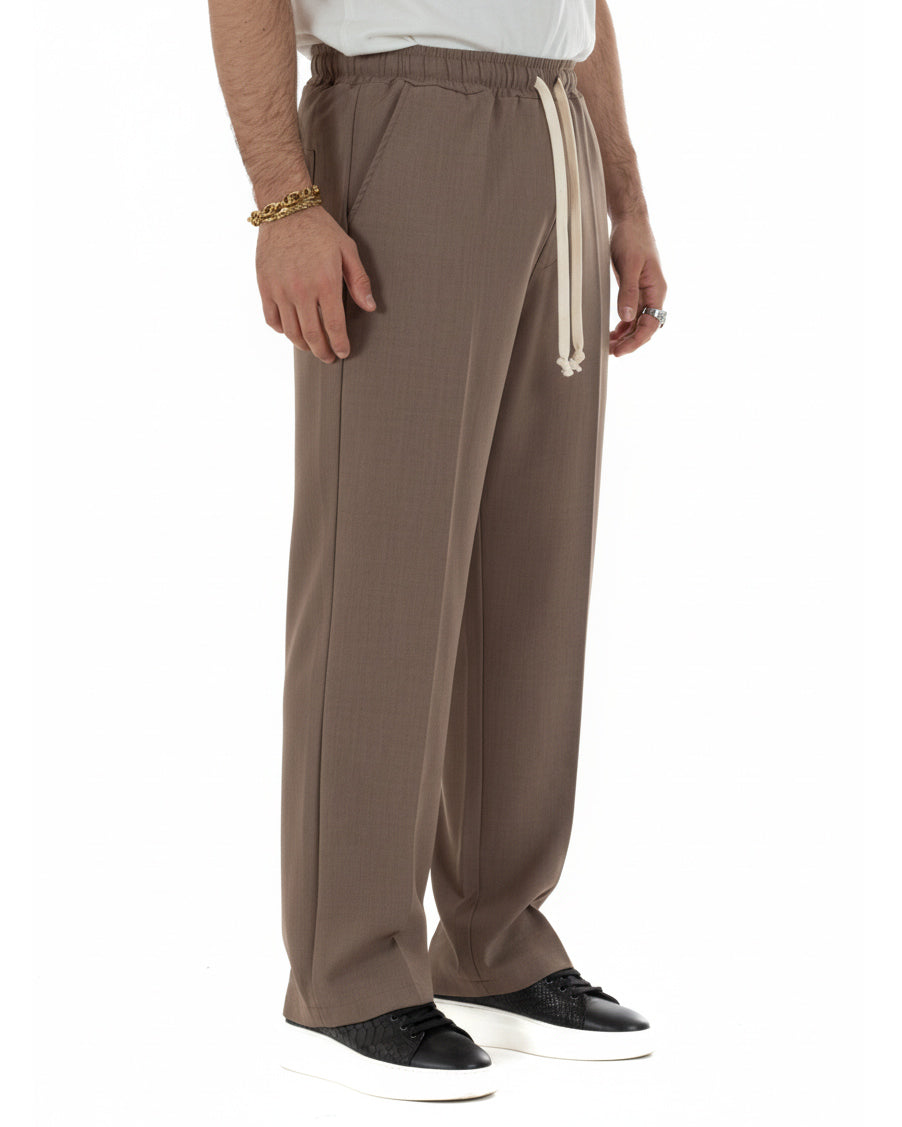 Vista laterale pantaloni uomo marrone oversize viscosa morbidi casual
